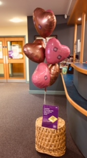 pink heart shaped balloons in front of reception